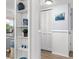 Bright entryway with built-in shelving and coat closet at 16308 Gulf Blvd # 209, Redington Beach, FL 33708