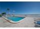 Inviting heated pool with oceanfront views and plenty of lounge chairs at 16308 Gulf Blvd # 209, Redington Beach, FL 33708
