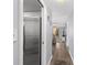 Bright hallway with stainless steel refrigerator and view into living area at 16308 Gulf Blvd # 209, Redington Beach, FL 33708