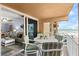 Ocean view balcony with table and chairs, perfect for relaxing and enjoying the coastal breeze at 16308 Gulf Blvd # 209, Redington Beach, FL 33708