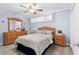 Bedroom with wooden furniture and ceiling fan at 16308 Gulf Blvd # 209, Redington Beach, FL 33708
