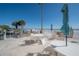 Outdoor grilling area with tables and seating, overlooking the ocean at 16308 Gulf Blvd # 209, Redington Beach, FL 33708