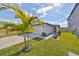 View of a one-story house with a red door and nicely landscaped yard at 9316 Channing Hill Dr, Ruskin, FL 33573