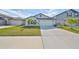 One-story house with a two-car garage and a well-maintained lawn at 9316 Channing Hill Dr, Ruskin, FL 33573