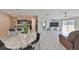 Open floor plan with kitchen island, stainless steel appliances, and living room with sliding glass doors at 9316 Channing Hill Dr, Ruskin, FL 33573