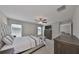 Well-lit bedroom with carpeted floor, a large bed, and a TV at 9316 Channing Hill Dr, Ruskin, FL 33573