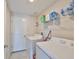Laundry room with washer, dryer, and shelving at 9316 Channing Hill Dr, Ruskin, FL 33573