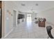 Spacious living room with tile floors, a large TV, and access to the backyard at 9316 Channing Hill Dr, Ruskin, FL 33573