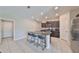 Kitchen features dark cabinetry, granite countertops, and breakfast bar at 9316 Channing Hill Dr, Ruskin, FL 33573