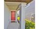 Red front door entryway with a covered porch and tile floor at 9316 Channing Hill Dr, Ruskin, FL 33573