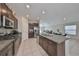 Modern kitchen with dark brown cabinets, granite countertops, and stainless steel appliances at 9316 Channing Hill Dr, Ruskin, FL 33573