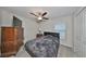 Bright bedroom with double bed, dresser, and ceiling fan at 9316 Channing Hill Dr, Ruskin, FL 33573