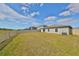 Large backyard with grassy lawn and a white vinyl fence at 9316 Channing Hill Dr, Ruskin, FL 33573