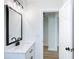 Modern bathroom with white vanity, quartz countertop, and black matte fixtures at 1751 28Th S St, St Petersburg, FL 33712