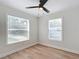 Bright bedroom with two windows, wood-look floors and ceiling fan at 1751 28Th S St, St Petersburg, FL 33712