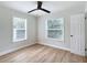Bright bedroom featuring light walls, wood-look floors, and ceiling fan at 1751 28Th S St, St Petersburg, FL 33712