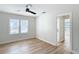 Bedroom with two windows, wood-look floors and ceiling fan at 1751 28Th S St, St Petersburg, FL 33712