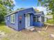 Front view of a charming blue house with a screened porch at 1751 28Th S St, St Petersburg, FL 33712