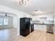 Modern kitchen with white cabinets, black appliances, and granite countertops at 1751 28Th S St, St Petersburg, FL 33712