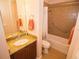 Bathroom featuring shower/tub, dark wood vanity with marble counter, and oval sink at 809 Chipper Dr, Sun City Center, FL 33573