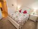 Comfortable bedroom with floral bedding and lamps on nightstands at 809 Chipper Dr, Sun City Center, FL 33573