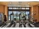 Bright gym with large windows overlooking palm trees, equipped with various exercise machines at 809 Chipper Dr, Sun City Center, FL 33573