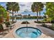 Relaxing outdoor hot tub near the pool with palm trees and lounge chairs creating a tranquil setting at 809 Chipper Dr, Sun City Center, FL 33573