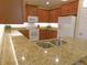 This kitchen features granite countertops, stainless steel appliances, and ample storage for all of your cooking essentials at 809 Chipper Dr, Sun City Center, FL 33573