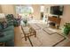 This living room features plush seating, a decorative rug, and sliding glass doors, creating a bright and airy atmosphere at 809 Chipper Dr, Sun City Center, FL 33573