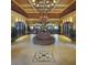 Elegant lobby featuring a decorative chandelier, tiled floors, and a central seating area with flowers at 809 Chipper Dr, Sun City Center, FL 33573
