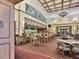 Spacious restaurant area with a long bar, tables, chairs, and coffered ceilings at 809 Chipper Dr, Sun City Center, FL 33573