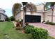 House exterior featuring a two-car garage with a retractable screen at 809 Chipper Dr, Sun City Center, FL 33573