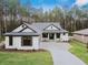 Two story home with gray and white exterior, two car garage, and paver driveway at 19411 Sheltered Hill Dr, Brooksville, FL 34601