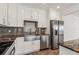 Modern kitchen with stainless steel appliances and white cabinets at 865 N Shore Dr, Anna Maria, FL 34216