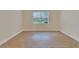 Bright bedroom with wood-look flooring and large window at 16216 Amethyst Key Dr, Wimauma, FL 33598