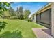 Private backyard with lush lawn and landscaping at 16216 Amethyst Key Dr, Wimauma, FL 33598