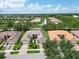 An aerial view of a house on a tree-lined street at 16216 Amethyst Key Dr, Wimauma, FL 33598