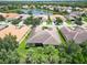 Aerial view of a house in a residential neighborhood with a lake at 16216 Amethyst Key Dr, Wimauma, FL 33598