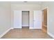 Bedroom with double door closet and wood-look flooring at 16216 Amethyst Key Dr, Wimauma, FL 33598