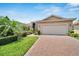One story house with a brick driveway and landscaped front yard at 16216 Amethyst Key Dr, Wimauma, FL 33598