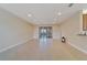 Spacious living room features tile floors and sliding glass doors at 16216 Amethyst Key Dr, Wimauma, FL 33598