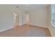 Bedroom with wood-look floors, door to bathroom, and window at 16216 Amethyst Key Dr, Wimauma, FL 33598