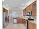 Kitchen with stainless steel appliances and wood cabinets at 16216 Amethyst Key Dr, Wimauma, FL 33598