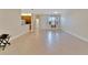 Open living area with tile floors and views of the kitchen and entry at 16216 Amethyst Key Dr, Wimauma, FL 33598