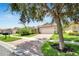 House exterior with a brick driveway and lush landscaping at 16216 Amethyst Key Dr, Wimauma, FL 33598