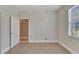 Bedroom with door to bathroom and large window at 16216 Amethyst Key Dr, Wimauma, FL 33598