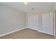 Bedroom with double door closet and wood-look flooring at 16216 Amethyst Key Dr, Wimauma, FL 33598