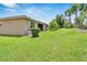 Private backyard with lush lawn and landscaping at 16216 Amethyst Key Dr, Wimauma, FL 33598
