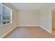 Bright bedroom with wood-look flooring and large window at 16216 Amethyst Key Dr, Wimauma, FL 33598