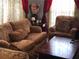 Living room with brown couch and armchair at 2905 W Cherry St, Tampa, FL 33607